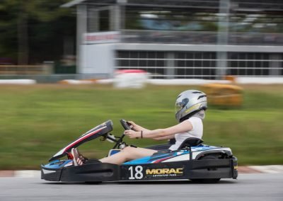 girl go kart racer racing through the fast turn around Malaysia's largest and most challenging circuit, Morac Adventure Park, Langkawi, Malaysia