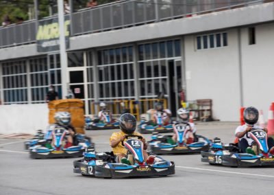 go kart racers leaving the pit lane after being cleared by the marshals to go racing