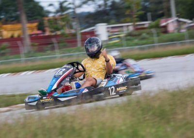 go kart racer on holiday in Langkawi, Malaysia giving a thumbs up at a slow turn while racer