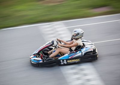 go kart girl racer at Morac Adventure Park, Langkawi, Malaysia crossing the checkered line