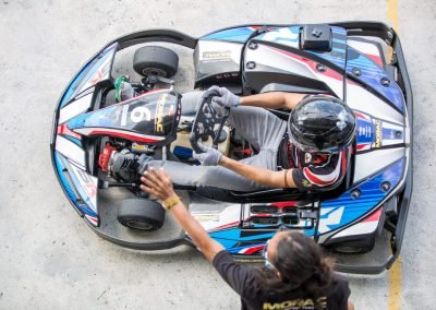 top shot of a go kart racer been given the green light to enter the track by the track marshal